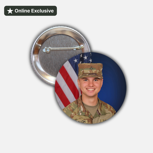 Two round pin-back buttons shown on a light gray background. One button displays a photo of a smiling soldier in camouflage uniform in front of an American flag and blue backdrop.